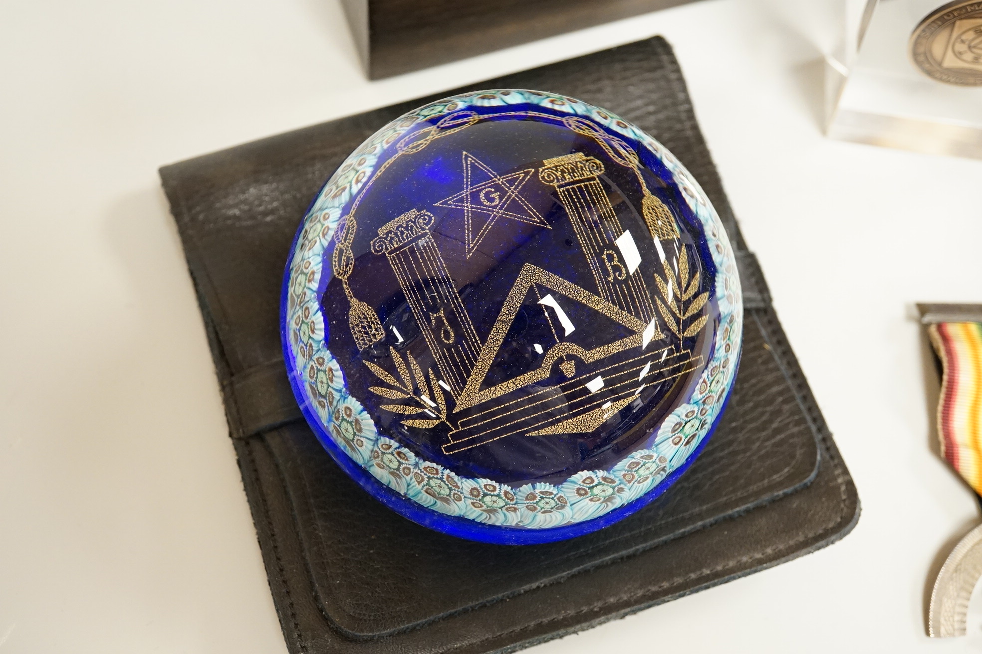 Masonic collectables including three paperweights, a cigarette box and two ribboned medals